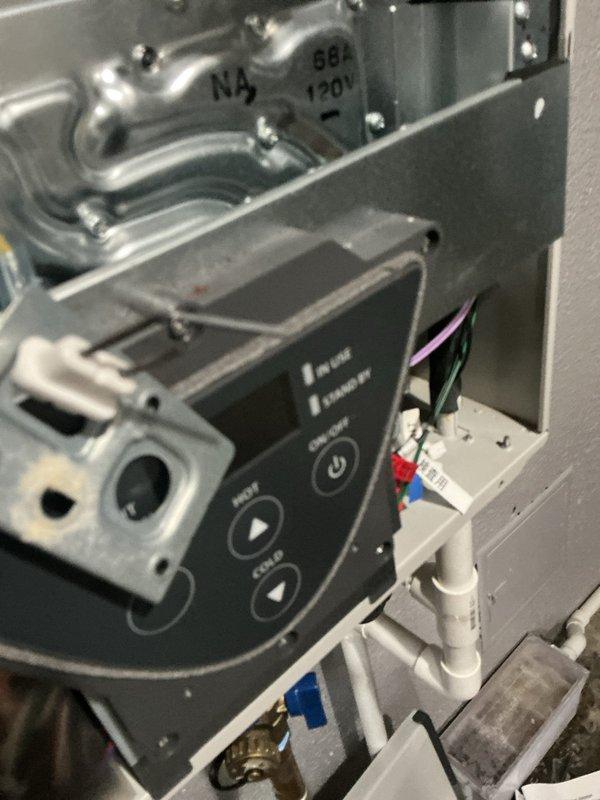 Responded to service call for tankless water heater displaying error code 391. Upon arrival, inspected the gas valve control module and associated components within the unit. Photographed the control panel showing operational buttons, indicator lights, and gas valve assembly for documentation purposes. Verified system connections including gas lines, PVC venting, electrical wiring, and control module mounting. Cleared error code 391 and tested unit operation through hot water demand cycle. Confirmed proper ignition sequence, gas valve function, and normal operating parameters. Unit returned to service with all indicators showing normal standby status.