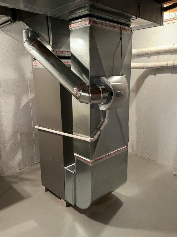 Completed comprehensive Gold Furnace Inspection on 10-month-old Lennox HVAC system and water heater located in basement mechanical room. Performed thorough visual inspection of furnace unit, verifying proper installation of ductwork connections, PVC condensate drainage system, and venting components. Inspected all accessible components including heat exchanger, blower assembly, gas connections, and electrical controls. Verified proper operation of safety devices and thermostat communication. Examined air conditioning system components and confirmed refrigerant lines, condensate drain, and electrical connections were secure and functioning properly. Checked water heater integration with HVAC system including all piping connections and pressure relief valves. All equipment found operating within manufacturer specifications with no deficiencies noted. System demonstrated proper airflow, ignition sequence, and temperature differential. Provided homeowner with maintenance recommendations fo