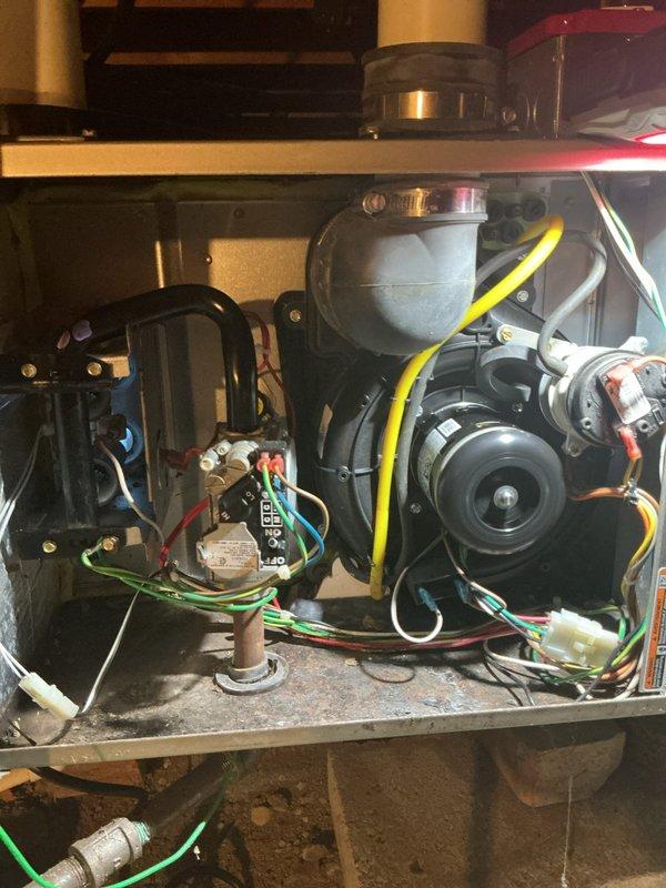 Completed comprehensive tune-up inspection on 15-year-old furnace system located in crawlspace. Performed thorough evaluation of all mechanical and electrical components including burner assembly, heat exchanger, blower motor, gas valve, and control board. Inspected thermostat operation, humidifier functionality, and hot water tank condition as part of standard maintenance protocol.

Identified failed inducer motor assembly requiring replacement. Ordered inducer motor assembly through Carrier Great Lakes with pickup scheduled at Livonia location. Unit tagged and customer advised of pending part arrival and installation. Documented all findings with photographic evidence showing internal component condition, wiring connections, and motor assembly. System operational status communicated to customer with callback number confirmed for scheduling return visit upon part receipt.