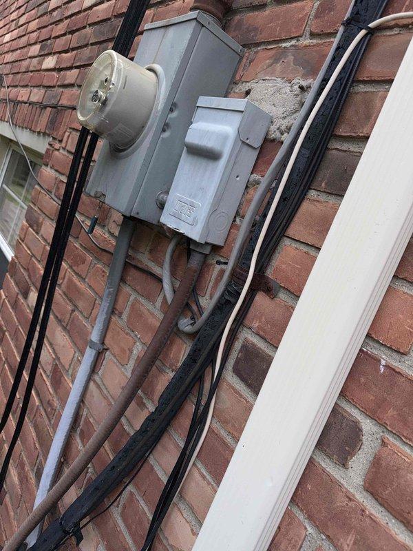 Responded to no cooling complaint on 15-year-old air conditioning unit located in attic. Upon arrival, confirmed system was running but discharging warm air instead of conditioned air. Performed diagnostic evaluation of outdoor condensing unit and indoor air handler. Inspected electrical connections at meter base and verified power supply to equipment. Assessed condenser unit exterior condition, noting age-related wear and outdoor exposure consistent with equipment age. Documented system configuration and current operating conditions with photographs for service records.