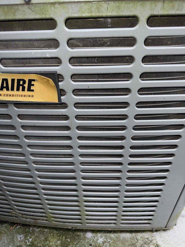 Responded to no cooling complaint on 15-year-old air conditioning unit located in attic. Upon arrival, confirmed system was running but discharging warm air instead of conditioned air. Performed diagnostic evaluation of outdoor condensing unit and indoor air handler. Inspected electrical connections at meter base and verified power supply to equipment. Assessed condenser unit exterior condition, noting age-related wear and outdoor exposure consistent with equipment age. Documented system configuration and current operating conditions with photographs for service records.