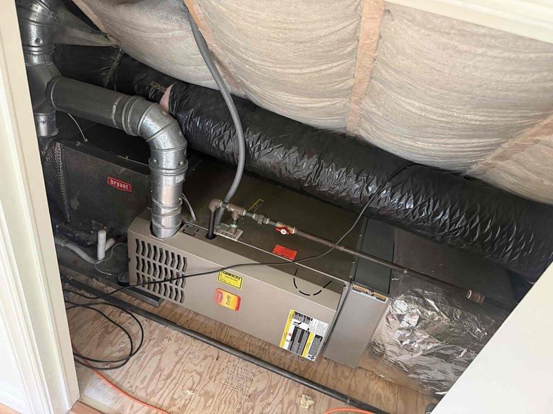Completed comprehensive tune-up and inspection on two forced air systems located in garage and second floor attic. Attic unit identified as Bryant air handler with associated ductwork and proper insulation in place. Performed standard maintenance procedures including filter inspection, blower assembly evaluation, and electrical connection verification on both units. Inspected outdoor condensing unit situated in side yard, confirmed proper clearances, checked refrigerant lines and electrical conduit connections. Both systems operational and ready for heating season.