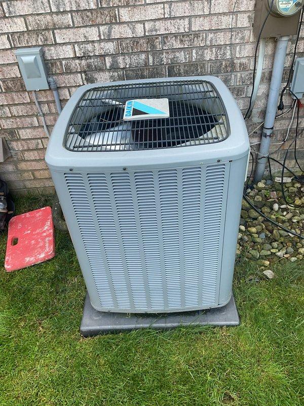 Completed comprehensive Gold Plan AC tune-up and maintenance inspection on residential cooling system. Unit was operating properly upon arrival with no reported issues. Performed standard preventive maintenance protocol including inspection of outdoor condenser unit positioned on concrete pad against exterior wall, verified proper airflow through louvered vents and checked fan operation beneath protective grille. Inspected electrical connections, conduit, and meter box mounted on exterior wall for secure connections and proper operation. Interior inspection included evaluation of Aprilaire humidistat control mounted on ductwork, confirmed device functionality and verified humidity settings aligned with manufacturer specifications for seasonal operation. System tested and confirmed to be operating within normal parameters with no deficiencies noted. All components functioning as designed.