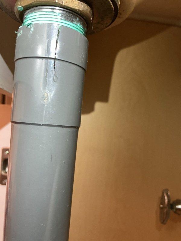 Responded to a bathroom toilet drainage issue that persisted after chemical drain cleaner application. Upon inspection, identified a cracked PVC drain pipe in the plumbing assembly connected to the fixture, which was preventing proper drainage. Replaced the damaged section of gray PVC pipe and rubber gasket at the threaded coupling connection point. Tested the toilet flush mechanism to verify proper drainage and confirmed complete resolution of the blockage issue.