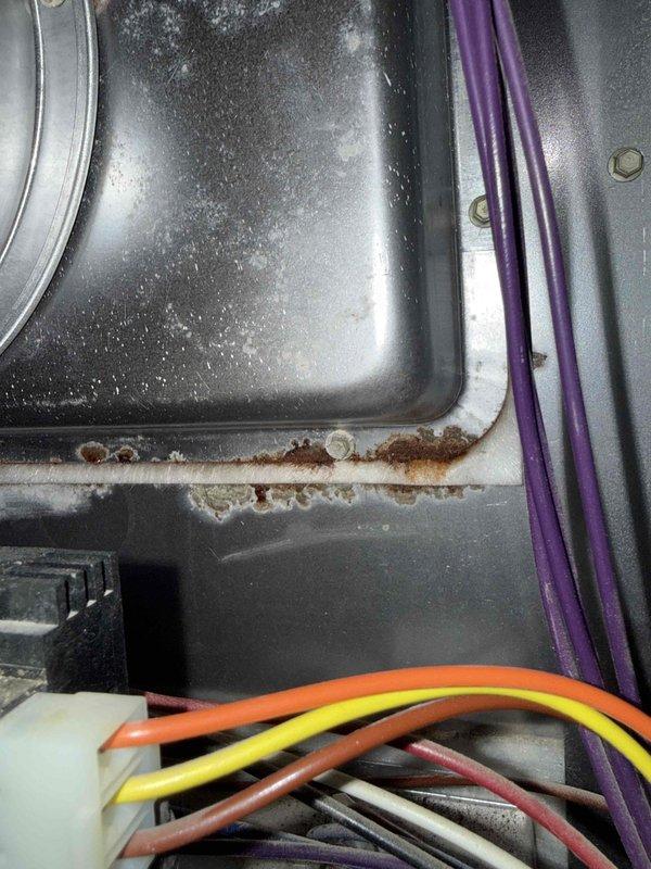 Completed comprehensive Gold Furnace Inspection on 13-year-old furnace unit located in basement. Performed electrical diagnostics using clamp multimeter to verify system performance and electrical draw. Inspection revealed rust and corrosion buildup along interior cabinet seams and access panel edges, indicating moisture exposure over time. All electrical connections, wiring harnesses, and control circuits were examined and found to be operational. Documentation photos captured for maintenance records.