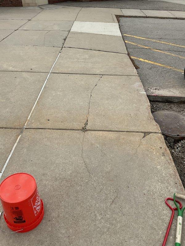 Responded to Miss Dig ticket #2026082605365 for excavation and repair of underground commercial plumbing piping. Utilized mini excavator to excavate trench through concrete sidewalk pavers and subsurface materials to access damaged underground piping system. Completed excavation work exposed utility lines for repair per approved estimate, with trench bordered by existing concrete sections to maintain structural integrity of surrounding pavement and minimize disruption to pedestrian walkway.
