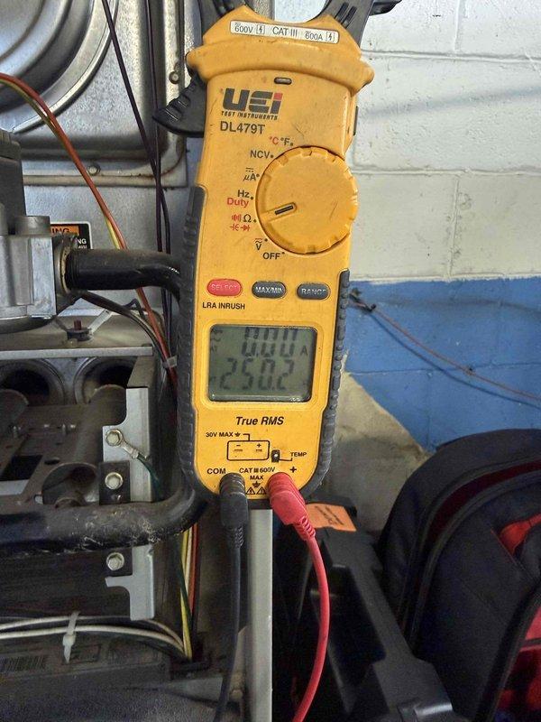 Performed comprehensive inspection and testing of commercial forced air furnace unit located in basement serving two office spaces. Conducted electrical diagnostics using digital clamp meter, recording amperage draw of 30.00A to verify proper motor operation and electrical load. Removed and inspected temperature sensor probe from control board, examining thermistor condition and wire connections to ensure accurate temperature monitoring and system cycling. Verified all electrical connections, control board functionality, and wire terminations throughout system. Tested unit operation through complete heating cycle, confirming proper ignition sequence, burner operation, and blower motor performance. All components found operating within normal parameters with no repairs required at this time.