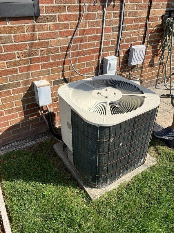 Conducted comprehensive assessment of 40-year-old non-operational air conditioning system and natural gas furnace located in basement. Evaluated existing outdoor condensing unit on concrete pad with associated refrigerant lines, electrical connections, and drainage components, documenting condition of brick-mounted electrical boxes and conduit routing. Inspected indoor furnace unit, ductwork configuration, and associated mechanical room components including water heater proximity and existing ventilation systems. Provided detailed replacement estimate for complete HVAC system upgrade to address equipment failure and obsolescence.