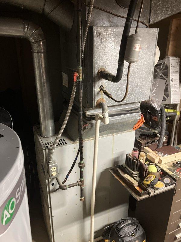 Conducted comprehensive assessment of 40-year-old non-operational air conditioning system and natural gas furnace located in basement. Evaluated existing outdoor condensing unit on concrete pad with associated refrigerant lines, electrical connections, and drainage components, documenting condition of brick-mounted electrical boxes and conduit routing. Inspected indoor furnace unit, ductwork configuration, and associated mechanical room components including water heater proximity and existing ventilation systems. Provided detailed replacement estimate for complete HVAC system upgrade to address equipment failure and obsolescence.
