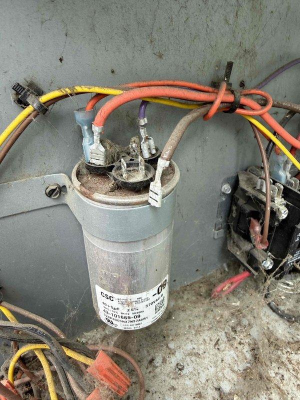 Responded to no cooling complaint on 10+ year old air conditioning unit located in basement. Upon arrival, confirmed outdoor condenser fan motor was operating but compressor was not running. Performed electrical diagnostics using clamp meter and identified failed dual run capacitor preventing compressor from starting. Replaced defective capacitor with proper rated replacement unit. Verified proper amperage draw on both compressor and condenser fan motor circuits. Tested system operation through complete cooling cycle and confirmed unit now providing adequate cooling with all components functioning within manufacturer specifications.