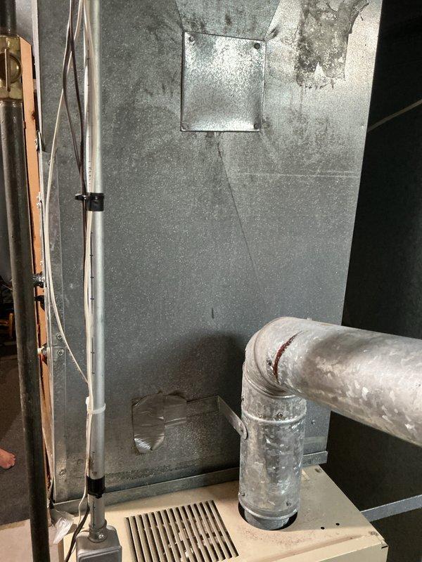 Completed estimate for replacement of two aging furnaces in basement of residential property under 1500 square feet. Both units are 33 and 34 years old and have reached end of service life. Inspected existing HVAC infrastructure including ductwork, condensate drainage systems, and mechanical room configuration. Documented current equipment specifications, duct connections, and installation parameters. Photographed existing furnace installations, sheet metal ductwork, flexible duct connections, PVC condensate lines, and drain pan assemblies to support replacement recommendations. Assessed mechanical room layout and clearances for new equipment installation. Provided comprehensive replacement options for dual furnace system upgrade.