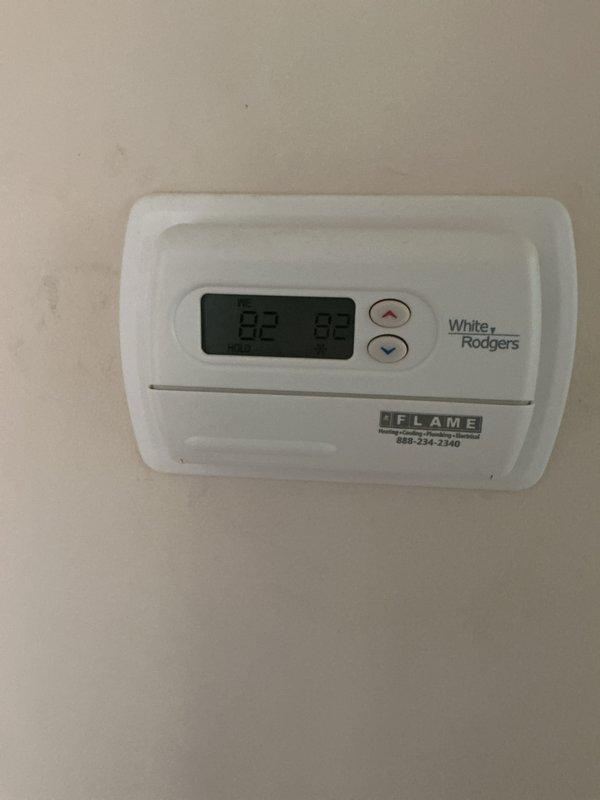 Completed comprehensive Gold AC inspection on 9-year-old air conditioning system and 3-year-old furnace located in basement. Performed full system evaluation including thermostat functionality check, verified White Rodgers digital thermostat displaying proper temperature readings with system operating normally. Inspected furnace unit, blower assembly, and air filtration system; noted heavy dust accumulation on cylindrical blower housing requiring attention during future maintenance. Verified air filter condition in black frame housing, checked flexible ductwork connections, and assessed overall system performance with all equipment functioning as designed at time of inspection.