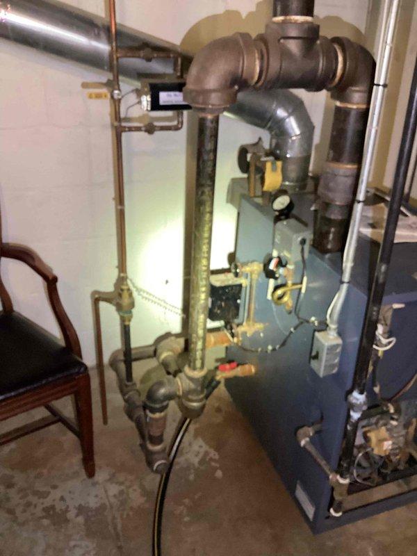 Responded to annual heating inspection request for ten-year-old basement boiler under Gold Plan maintenance. Upon arrival, performed comprehensive diagnostic evaluation of steam boiler system and conducted combustion analysis testing. Testing revealed elevated carbon monoxide levels in flue gas, indicating incomplete combustion and potential safety hazard requiring immediate attention.

Conducted thorough visual inspection of boiler unit, heat exchanger, burner assembly, venting system, and associated piping infrastructure. Examined blue-painted boiler cabinet, copper supply and return lines, galvanized venting, brass fittings, and control components. Assessed condition of circulation system including valves, pressure relief devices, and electrical controls. Documented existing equipment configuration with photographic evidence showing piping layout, connection points, ductwork, and overall mechanical room setup.

Based on elevated CO readings and age of equipment, determined that boil