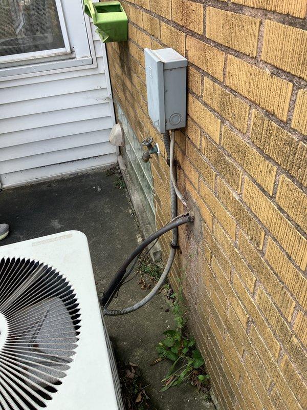 Responded to service call for water leaking from condensate pump during air conditioning operation. Upon inspection, found 26-year-old furnace with cracked heat exchanger and low R22 refrigerant levels in the existing system. Given the age of the equipment, multiple component failures, and the obsolete R22 refrigerant, provided estimate for complete HVAC system replacement including new furnace and air conditioning unit. Documented existing exterior equipment location and electrical service connections for replacement specifications.