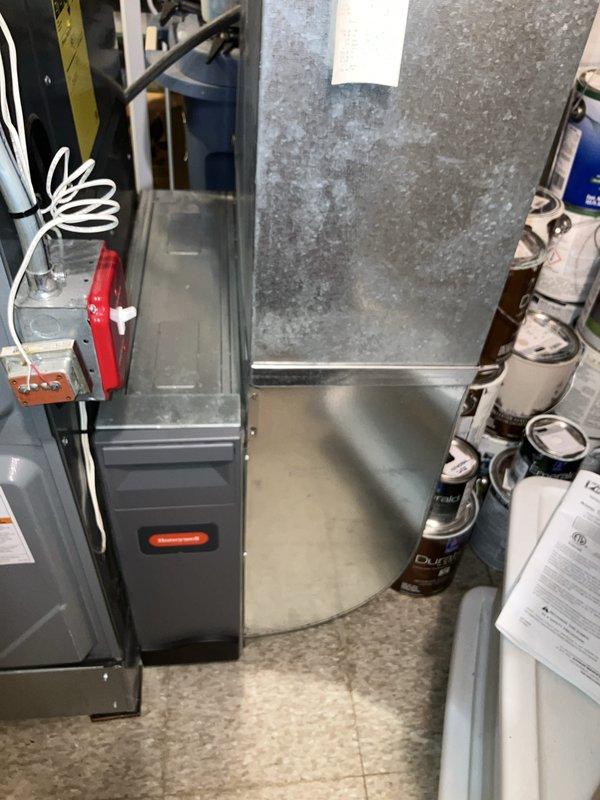 Performed equipment evaluation on 21-year-old air conditioning system located in basement to provide replacement estimate. Inspected existing furnace/air handler unit showing significant dust accumulation and operational wear, along with associated ductwork and electrical components. Assessed thermostat functionality, currently operating in cooling mode and maintaining proper temperature control at 71-72 degrees. Documented equipment condition through photographs and provided homeowner with comprehensive replacement options based on system age and current state of equipment.