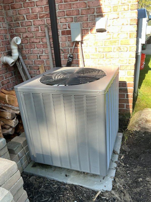 Conducted comprehensive assessment of 10-year-old residential air conditioning system experiencing compressor failure and producing hot air instead of cooling. Evaluated outdoor condenser unit located on concrete pad at building exterior and confirmed compressor malfunction requiring full system replacement. Presented replacement options and equipment specifications to homeowner for new AC installation to restore cooling functionality.