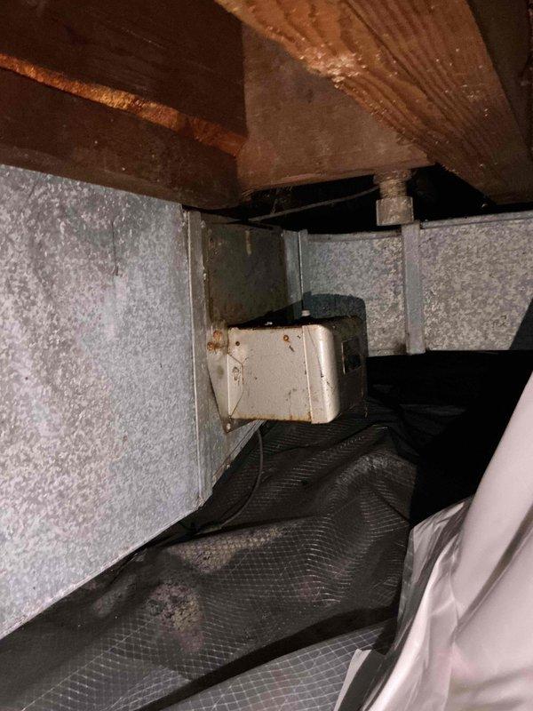 Responded to service call for alarm activation on recently installed equipment. Upon inspection in crawl space, identified water accumulation in drip pan triggering safety alarm on humidification system. Removed two humidifiers from crawl space to resolve the issue. Verified remaining equipment continued to operate properly following removal. Photographically documented existing conditions including HVAC ductwork, insulation, and mechanical components in confined space prior to completing work.