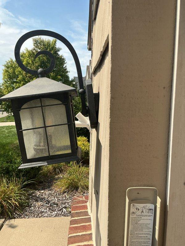 Completed comprehensive whole home electrical inspection for rental property. Evaluated exterior lighting fixture mounted on front wall, confirming proper installation and functionality of decorative lantern-style fixture with intact glazing and secure wall mounting. Inspected main electrical service equipment including meter base, digital electric meter, and exterior junction boxes with associated conduit runs, verifying proper grounding, secure connections, and code-compliant installation of all exterior electrical components.