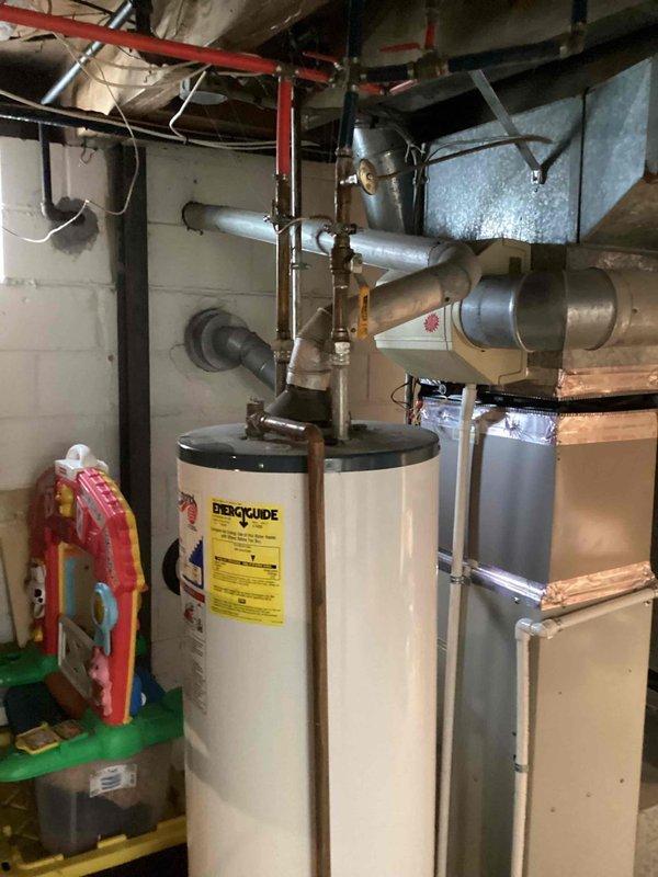 Provided equipment replacement estimate for aging natural gas furnace located in basement with suspected cracked heat exchanger causing intermittent operation. Assessed existing unit configuration, ductwork connections, and available installation space to determine appropriate replacement options. Documented current system specifications and photographed equipment for proposal preparation.