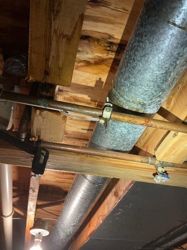 Responded to water leak complaint originating from ceiling. Inspected basement crawlspace and identified source of leak in copper supply line near junction with HVAC ductwork. Repaired compromised pipe fitting and verified all connections were secure. Confirmed no active leaking and advised homeowner to monitor for any recurrence.