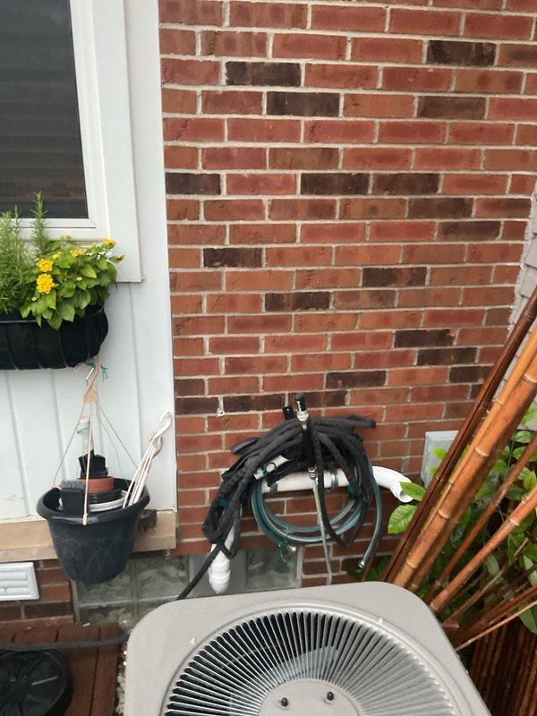 Addressed City of Sterling Heights mechanical code violation regarding furnace venting clearance requirements from operable windows and doors. Relocated or modified furnace venting system to ensure compliance with municipal regulations, which mandate 4-foot clearance for indirect vented (single-pipe) furnaces or 12-inch clearance for direct vented (two-pipe) furnaces from operable openings. Documented installation with photographic evidence showing exterior HVAC equipment placement and building configuration to verify code compliance.