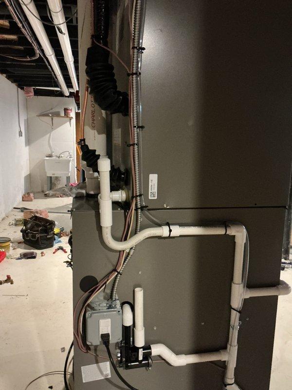 Completed full HVAC system installation including 90,000 BTU gas furnace, 4-ton air conditioning unit with left-side configuration, 50-gallon standard water heater, humidifier, and condensate pump with drain line routed to sink. Installed all refrigerant lines with proper insulation, PVC venting for high-efficiency furnace, electrical conduit and wiring throughout, and mounted necessary electrical disconnects and junction boxes. Mechanical permit obtained for furnace, water heater, humidifier, and air conditioning components; electrical reconnection work flagged for licensed electrician to complete final power connections to panels and equipment.