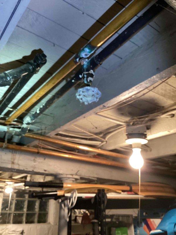 Responded to annual furnace maintenance call and discovered system was actually a boiler approximately 40 years old located in basement. Upon inspection, boiler was found to be inoperable and required shutdown. Assessment revealed failed zone valves in the hydronic heating system, with red circulator pump and associated piping network showing signs of age and wear. Gas line, supply and return piping, and distribution manifold were documented. Due to age of equipment and extent of repairs needed, recommended full boiler replacement along with new zone valves. Senior sales staff requested for comprehensive estimate preparation.