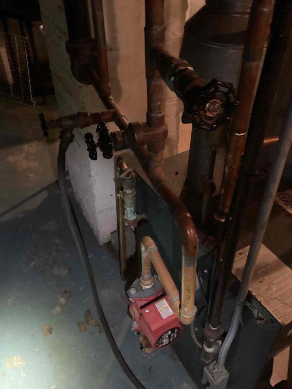 Responded to annual furnace maintenance call and discovered system was actually a boiler approximately 40 years old located in basement. Upon inspection, boiler was found to be inoperable and required shutdown. Assessment revealed failed zone valves in the hydronic heating system, with red circulator pump and associated piping network showing signs of age and wear. Gas line, supply and return piping, and distribution manifold were documented. Due to age of equipment and extent of repairs needed, recommended full boiler replacement along with new zone valves. Senior sales staff requested for comprehensive estimate preparation.