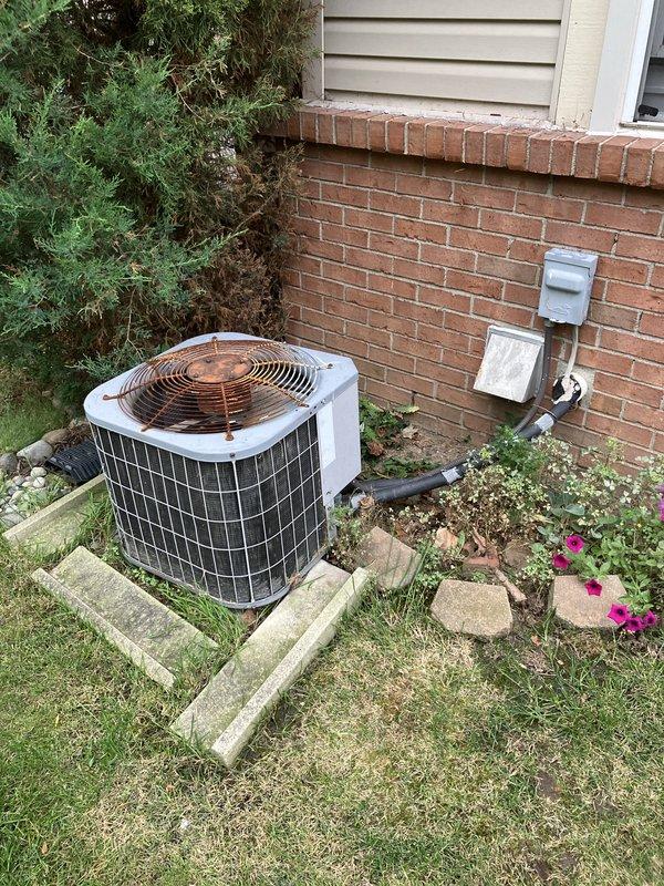 Responded to service call for non-operational air conditioning system affecting entire residence. Upon arrival, inspected 25-year-old outdoor condensing unit located at rear of property, noting significant age-related deterioration including visible rust and discoloration on fan grille and housing components. Conducted comprehensive full system evaluation of both outdoor condenser unit and indoor Honeywell thermostat control to assess equipment condition and determine viability of repair versus replacement. Based on unit age exceeding typical equipment lifespan and observed wear patterns, provided detailed estimate for complete HVAC system replacement to restore cooling functionality to the home.