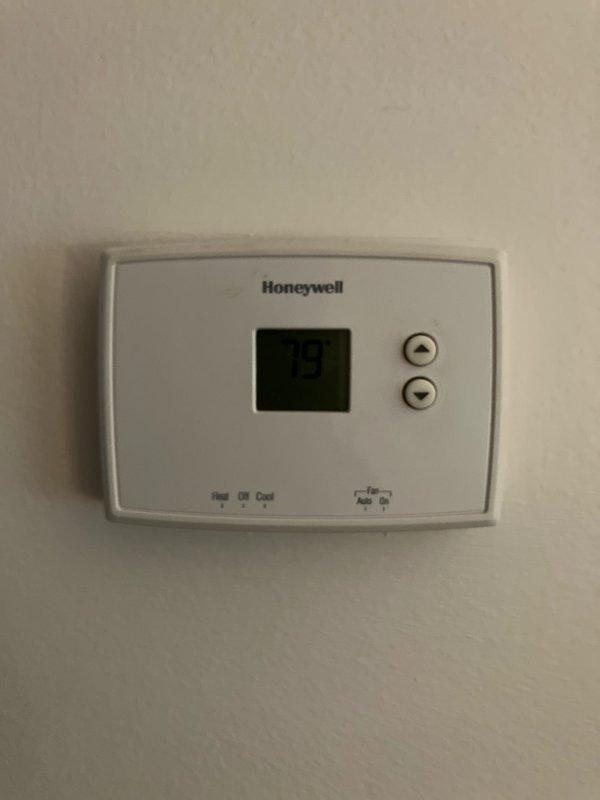 Responded to service call for non-operational air conditioning system affecting entire residence. Upon arrival, inspected 25-year-old outdoor condensing unit located at rear of property, noting significant age-related deterioration including visible rust and discoloration on fan grille and housing components. Conducted comprehensive full system evaluation of both outdoor condenser unit and indoor Honeywell thermostat control to assess equipment condition and determine viability of repair versus replacement. Based on unit age exceeding typical equipment lifespan and observed wear patterns, provided detailed estimate for complete HVAC system replacement to restore cooling functionality to the home.