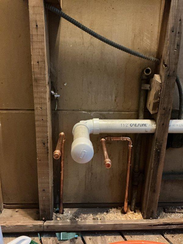 Responded to reported leaking pipe originating from basement area. Upon inspection, identified compromised plumbing assembly in exposed wall cavity consisting of copper supply lines and PVC drain system. Accessed affected area through interior wall framing to evaluate extent of water damage and source of leak. Performed necessary repairs to copper piping connections and verified proper sealing of all joints. Tested system for pressure integrity and confirmed leak resolution with no active water discharge present upon completion.