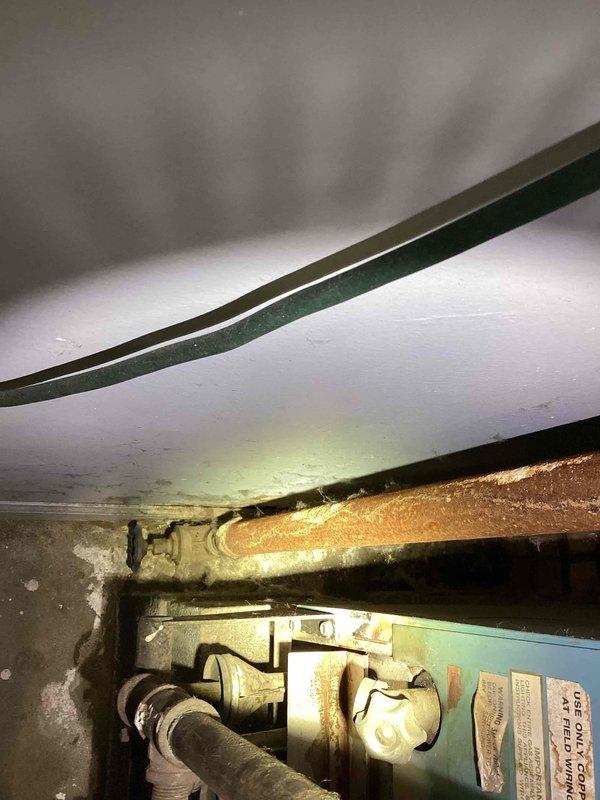 Conducted site assessment for non-operational 10+ year old natural gas boiler system requiring replacement. Evaluated existing hot water radiant heating system and identified leaking radiant pipes in need of repair. Documented electrical panel configuration and existing HVAC infrastructure, noting aged mechanical components with visible corrosion and patina on piping. Provided comprehensive quote for boiler replacement and radiant pipe leak repair, with recommendation that plumbing contractor may be required for complete resolution of radiant system issues.