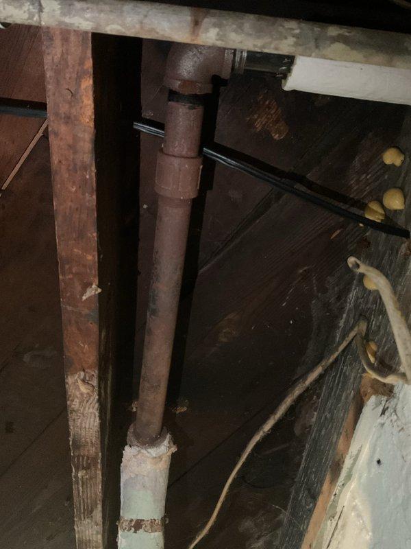 Responded to service call for leaking water heater in basement of 50-year-old residential property. Upon inspection, discovered heavily corroded boiler system with significant rust damage to vertical supply piping and deteriorating infrastructure throughout the mechanical space. Observed extensive water damage and staining on basement walls surrounding the water meter assembly, indicating prolonged moisture intrusion. Customer reported unit losing complete water capacity every 2-3 hours, requiring manual refilling before operation, with leakage occurring from one specific side when system is activated. Unit had not been operated since previous year. Documented existing conditions through photography, capturing severely corroded piping, aged structural components, and water-damaged surfaces. Assessed system for potential auto-fill capabilities as requested. Recommended evaluation by boiler specialist to determine extent of corrosion damage, viability of repairs versus replacement, and f