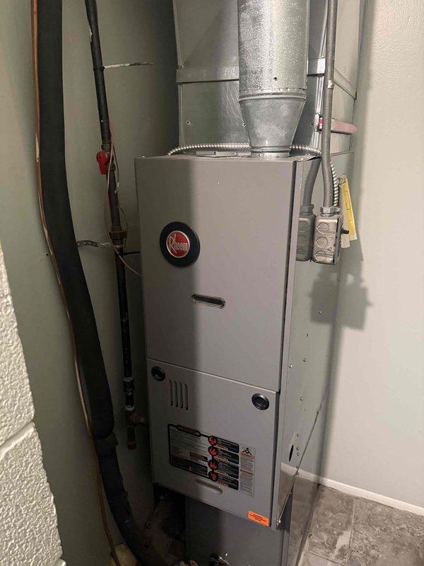 Completed Gold Furnace Inspection on a 2018 Rheem forced air heating system located on the main level near the garage. Performed comprehensive visual inspection of all accessible components including blower motor assembly, gas valve, flame sensor, ignition system, electrical connections, and ductwork. Verified all wiring connections secure with no signs of damage or deterioration, inspected gas valve operation and connections, examined blower motor and housing for proper operation, and confirmed all safety controls functioning as designed. All components found in good working condition with no visible signs of rust, corrosion, or wear. Unit operating normally at time of inspection.