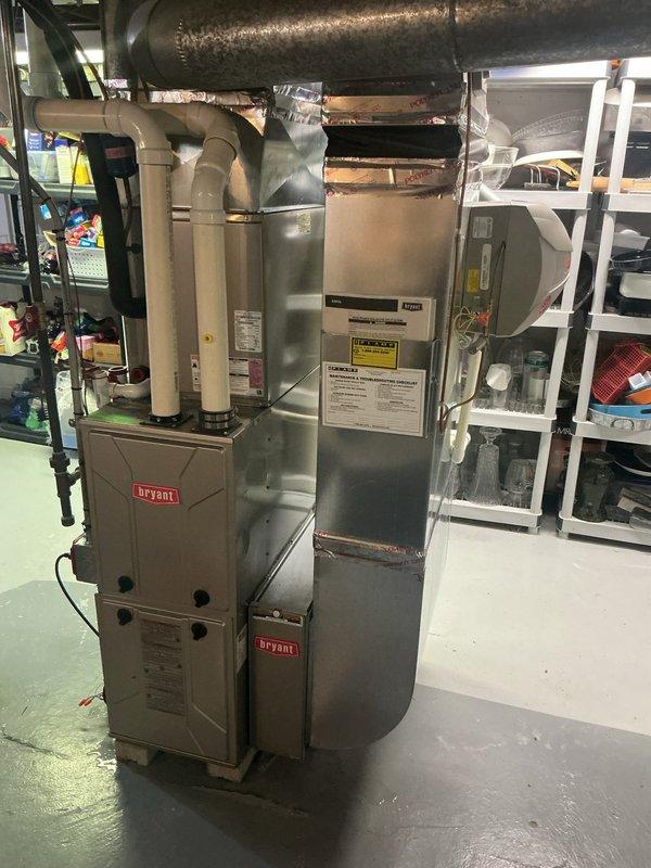 Responded to service call for AC system not running, with unit clicking on briefly then shutting off immediately. Upon arrival, inspected Bryant HVAC system located in basement, installed June 2015. Performed diagnostic evaluation of thermostat communication, control board functionality, and safety switch operation to identify cause of short cycling condition that has prevented system operation since previous service visit.