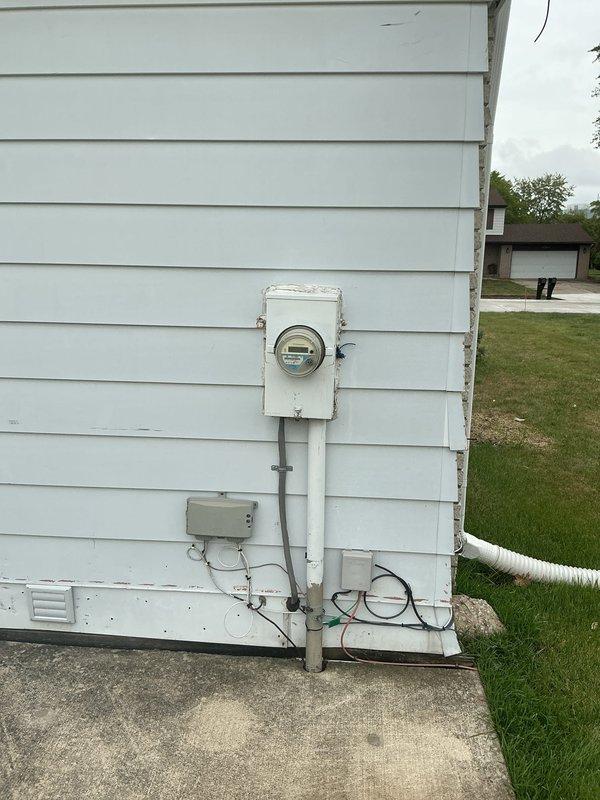 Completed comprehensive whole home electrical inspection of residential property. Evaluated exterior electrical service components including weathered meter box, disconnect junction box, and associated conduit connections, as well as interior main electrical panel mounted in basement utility area. All visible electrical infrastructure, wiring, and panel components were examined for code compliance, safety concerns, and proper installation standards.