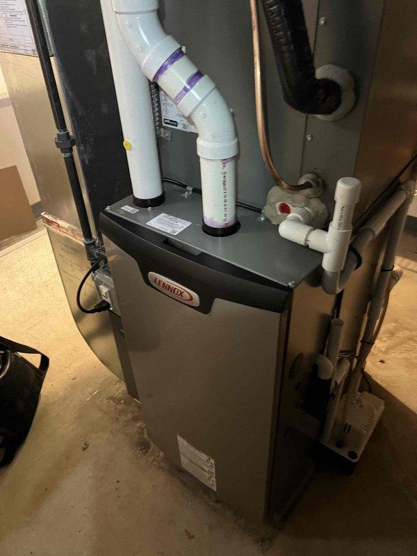 Completed comprehensive Gold AC Inspection on 1-year-old Lennox furnace and air conditioning system located in basement. Performed thorough visual inspection of furnace cabinet, verified proper PVC intake and exhaust venting connections, inspected refrigerant line sets, and confirmed condensate drain line functionality. Conducted electrical diagnostic testing at disconnect box using digital multimeter to verify proper voltage and amperage readings across all connections and terminals. All components found operating within manufacturer specifications with no immediate service needs identified at this time.
