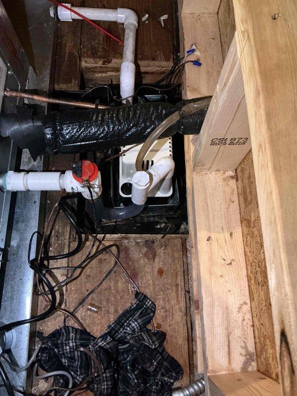 Responded to call for AC leaking through ceiling on 3-year-old system located in attic. Upon inspection, found condensate drainage issue with standing water present in drain pan and condensate pump area. Cleared clogged condensate drain line, verified proper pump operation, and tested drainage flow to ensure water is properly evacuating from the system to prevent further ceiling water damage.