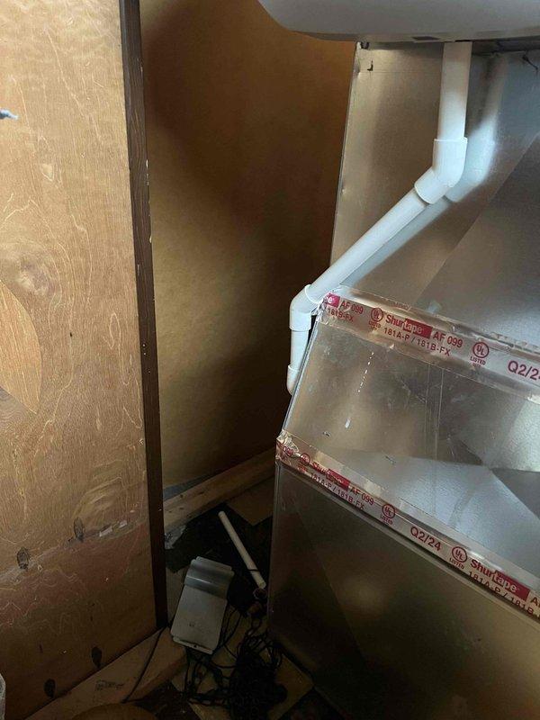 Completed comprehensive Gold AC Inspection on a 10+ year old single-unit system with air handler located in basement. Equipment was operational at time of service. Performed thorough multi-point inspection including visual assessment of air handler installation, refrigerant line insulation, condensate drainage system, and electrical connections. Verified proper PVC condensate drain routing and checked all accessible mechanical components. System found to be functioning within normal parameters. Documentation completed with photographic records of equipment installation and surrounding utility area.