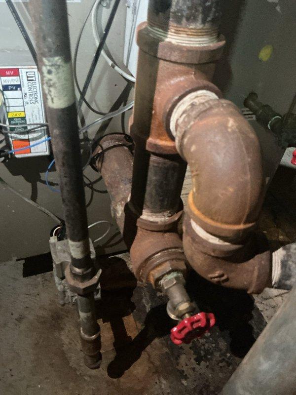 Responded to service call for 15-year-old boiler system located in basement. Upon inspection, identified severely corroded and deteriorated metal piping requiring replacement due to advanced oxidation and structural compromise. Documented existing conditions showing aged copper and steel piping with significant rust buildup, threaded connections showing wear, and overall system degradation consistent with equipment age. Assessed piping infrastructure including exposed ceiling joists where supply lines run, noting multiple pipe materials and connections in need of attention. Provided customer with findings and recommendations for necessary pipe replacement to restore safe and proper boiler operation.