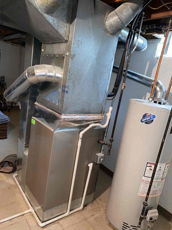 Completed estimate for replacement of 20+ year old Bryant air conditioning system and natural gas furnace located in basement mechanical room. Current equipment operational but aging beyond recommended service life. Assessed existing HVAC infrastructure including ductwork distribution system, PVC condensate drainage lines, and equipment accessibility for replacement installation planning.