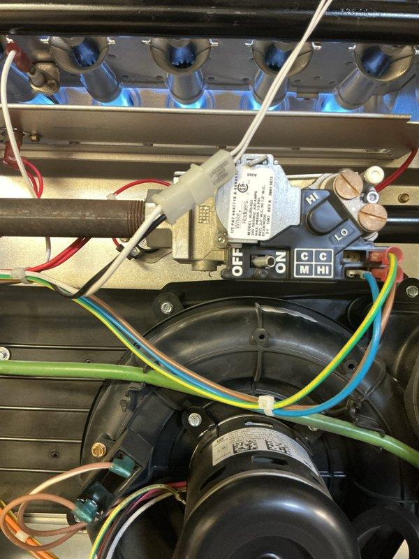 Completed annual preventative maintenance inspection on 11-year-old Bryant furnace system located in basement as part of Gold Plan membership. Performed comprehensive visual inspection of all major components including heat exchanger, burner assembly, gas valve, and draft inducer motor. Verified proper ignition sequence and observed clean blue flame pattern across all burners, indicating optimal combustion. Inspected gas valve controls and associated wiring connections for proper operation and secure terminations. Examined blower motor assembly and draft inducer for signs of wear or deterioration. Removed and inspected air filter, noting diamond-pattern mesh design and checking for proper fit within black frame housing. Verified all electrical connections and control wiring throughout system showing appropriate color coding and secure connections. Checked ductwork connections and mounting brackets for stability. System operational testing confirmed all components functioning within nor