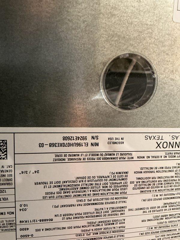 Completed comprehensive Gold Furnace Inspection on a forced-air heating system located in basement with unit over 10 years old. Performed thorough visual examination of furnace components, inspected burner assembly through access port, verified proper ventilation and flue connections, and documented equipment condition with photographs of internal mechanisms and manufacturer specifications panel. All systems operational at time of inspection.
