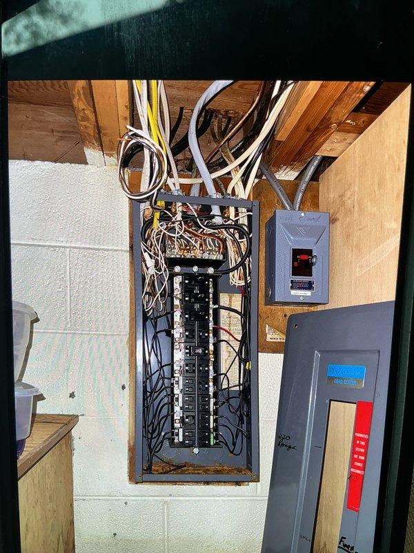 Performed comprehensive inspection of main electrical panel and associated distribution equipment. Examined all circuit breakers for proper operation, secure connections, and appropriate amperage ratings. Verified panel wiring integrity, including neutral and ground bus bar connections. Inspected conduit runs and wire routing from panel to ceiling joists. Evaluated secondary electrical boxes including disconnect and control panels mounted adjacent to main service panel. All components found to be functioning properly with no immediate safety concerns identified.