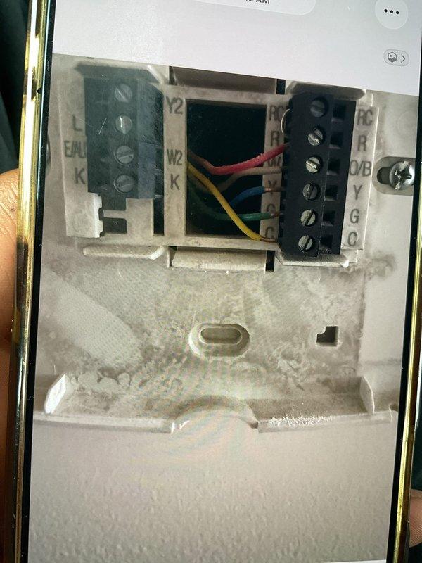 Responded to complaint of air conditioning system unable to maintain set temperature during peak afternoon hours around 5 PM, with extended recovery time. Inspected Honeywell programmable Wi-Fi thermostat and verified wiring configuration at terminal blocks, confirming proper connections of R, Y, G, and auxiliary wires. Noted thermostat displaying "Wi-Fi Signal Lost" error, indicating potential communication issues affecting system scheduling and temperature control algorithms. Addressed thermostat connectivity and programming settings to restore proper cooling cycle operation during high-demand periods.