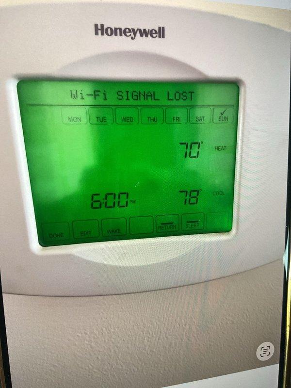 Responded to complaint of air conditioning system unable to maintain set temperature during peak afternoon hours around 5 PM, with extended recovery time. Inspected Honeywell programmable Wi-Fi thermostat and verified wiring configuration at terminal blocks, confirming proper connections of R, Y, G, and auxiliary wires. Noted thermostat displaying "Wi-Fi Signal Lost" error, indicating potential communication issues affecting system scheduling and temperature control algorithms. Addressed thermostat connectivity and programming settings to restore proper cooling cycle operation during high-demand periods.