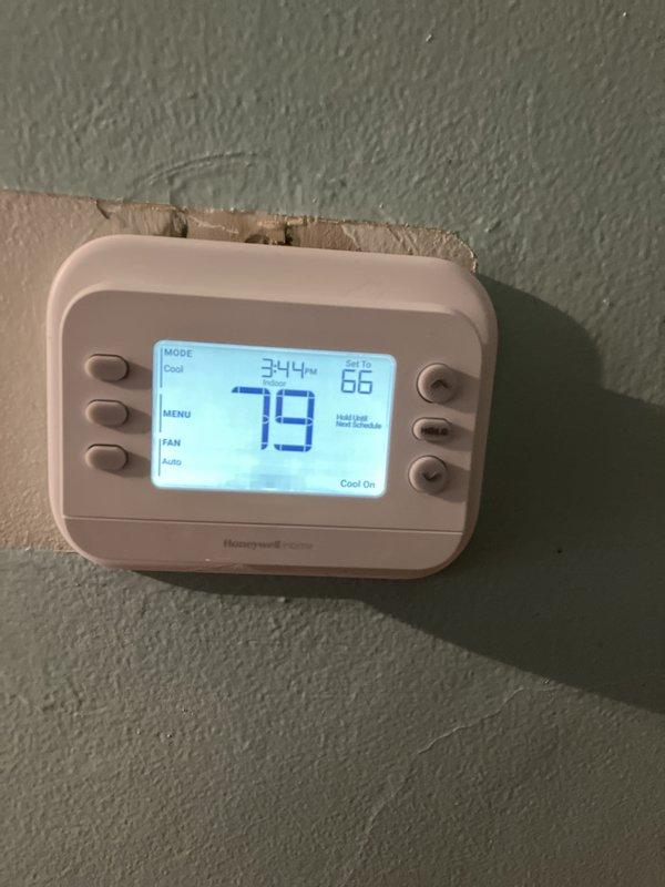Completed full HVAC system replacement including installation of 70,000 BTU furnace and 2-ton air conditioning unit in rear yard location. Installed new Honeywell digital thermostat, humidifier, and condensate pump with proper PVC drainage piping routed along exterior brick wall. Reconnected all electrical and mechanical components, obtained mechanical and electrical permits, and verified system operation with thermostat displaying proper cooling function.