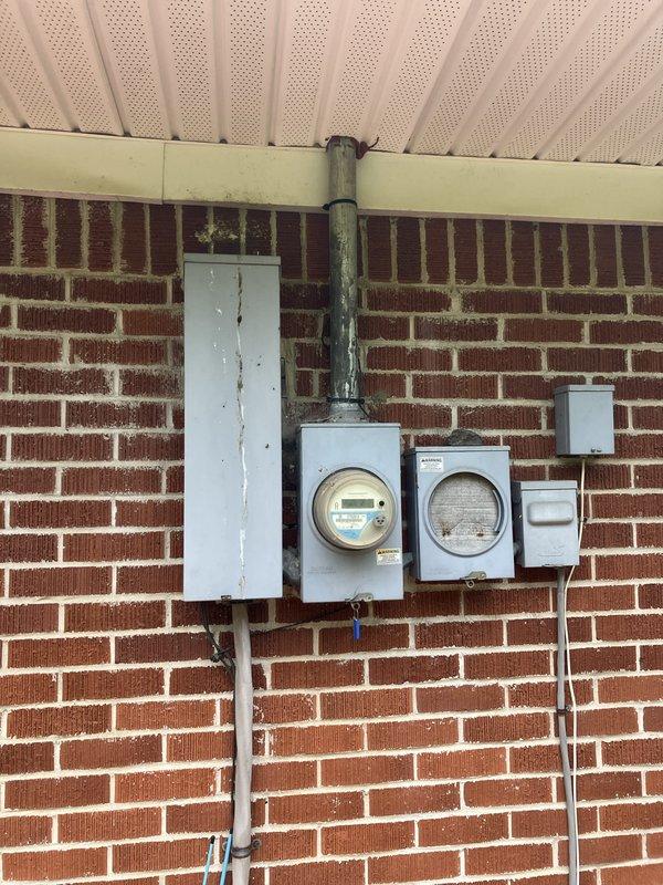 Conducted comprehensive site evaluation for new whole home generator installation at manufactured home. Assessed existing electrical service panel, meter configuration, and natural gas meter location on exterior brick wall to determine optimal generator placement and utility connection points. Documented current electrical infrastructure including main service panel, digital smart meter, and disconnect switches, as well as gas meter reading 581600 cubic feet with associated supply piping. Photographed installation site conditions to develop accurate proposal for generator system integration with existing 200-amp electrical service and natural gas supply line.