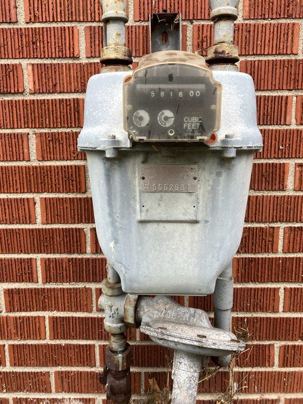 Conducted comprehensive site evaluation for new whole home generator installation at manufactured home. Assessed existing electrical service panel, meter configuration, and natural gas meter location on exterior brick wall to determine optimal generator placement and utility connection points. Documented current electrical infrastructure including main service panel, digital smart meter, and disconnect switches, as well as gas meter reading 581600 cubic feet with associated supply piping. Photographed installation site conditions to develop accurate proposal for generator system integration with existing 200-amp electrical service and natural gas supply line.