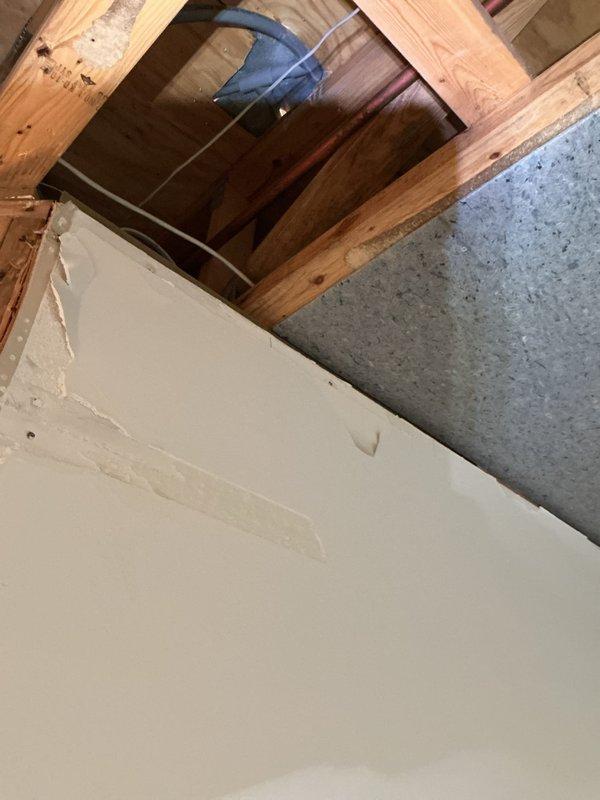 Responded to service call for reported boiler leak in basement of residential property. Upon inspection, identified leak originating from compromised hose connection on 10+ year old boiler system. Examined radiant heating system components and associated piping infrastructure. Assessed condition of affected flooring area showing moisture damage and verified extent of water intrusion. Inspected ceiling cavity and structural elements for secondary water damage. Documented system configuration and leak source with photographic evidence. Repaired faulty hose connection, pressure tested system to verify seal integrity, and confirmed proper operation of boiler unit. Monitored system through complete heating cycle with no further leakage detected.